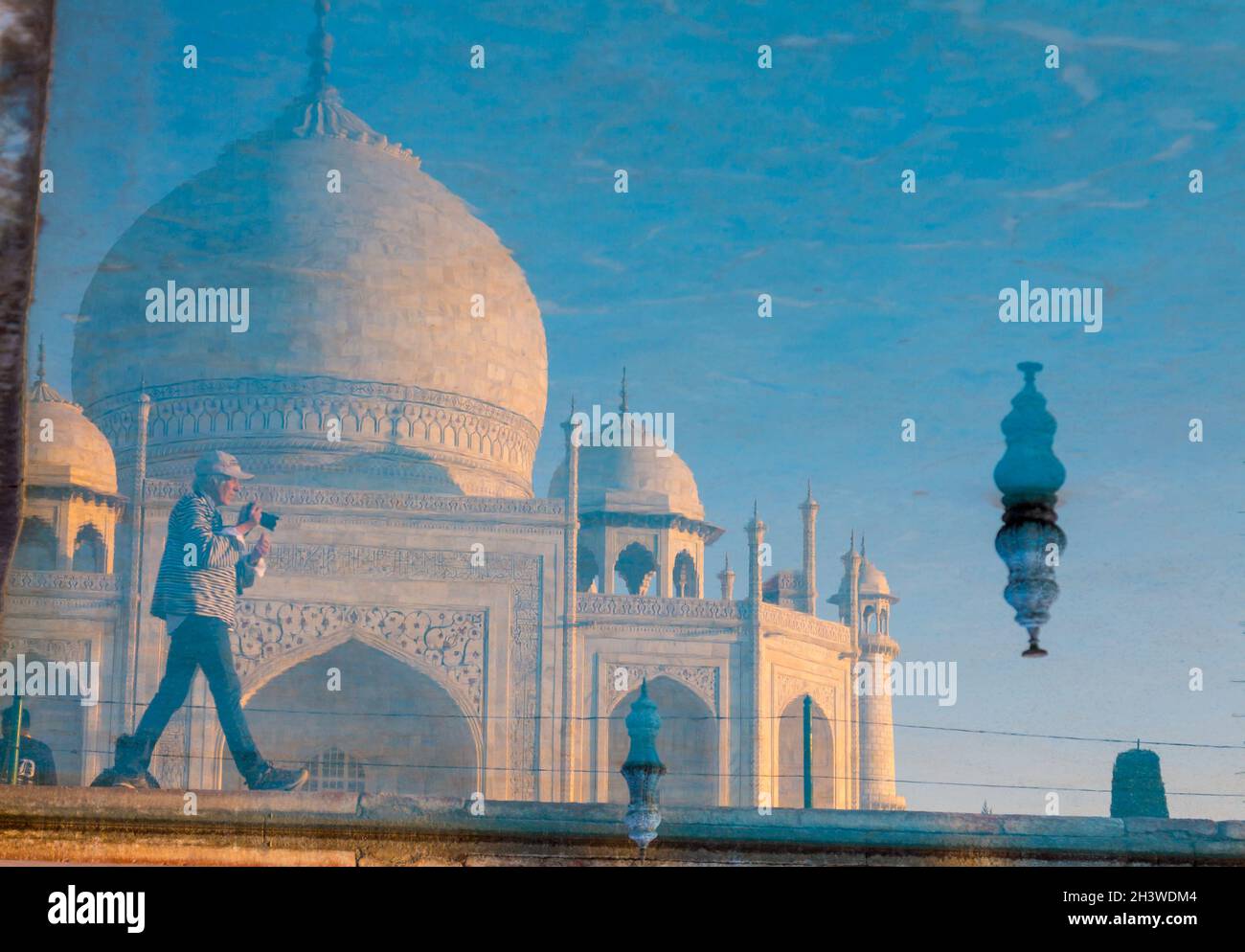 Taj Mahal and a photographer reflected in the garden's pool Stock Photo