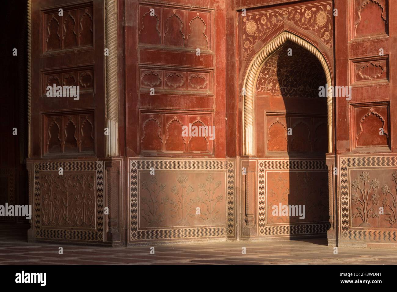 Doorway in the Taj Mahal complex mosque lit by the early-morning sun Stock Photo