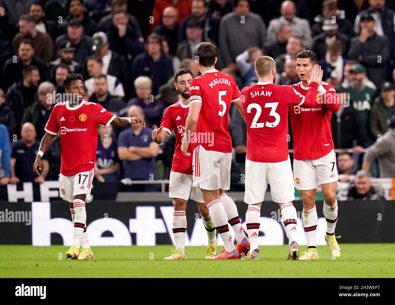 Manchester United's Cristiano Ronaldo (right) celebrates with team-mate Luke Shaw after scoring their side's first goal of the game during the Premier League match at Tottenham Hotspur Stadium, London. Picture date: Saturday October 30, 2021. Stock Photo