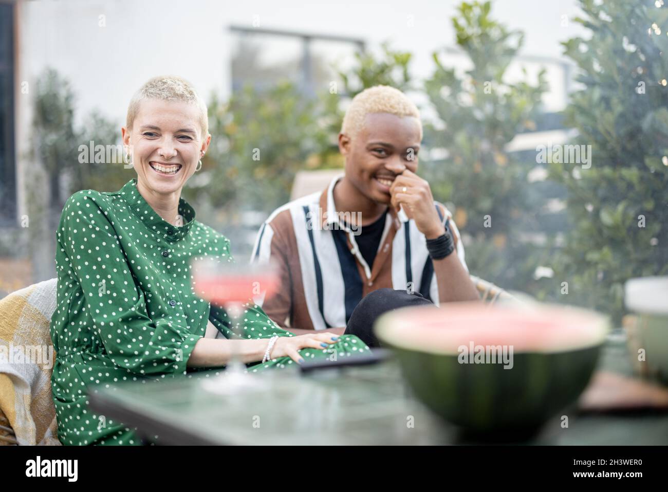 Multiracial couple having dinner at their backyard Stock Photo