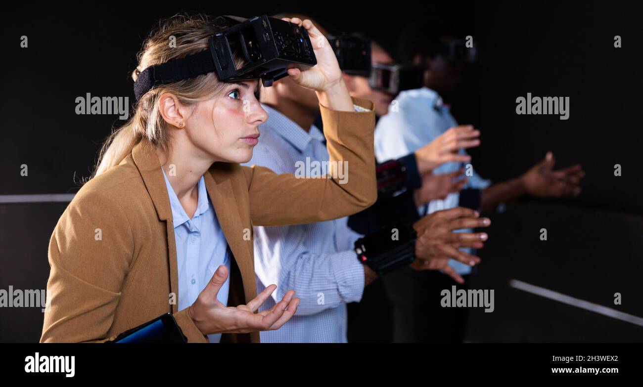 Woman using virtual reality headset and gesturing Stock Photo