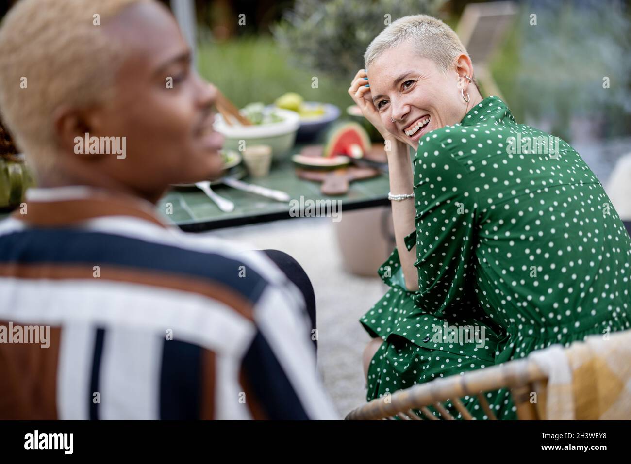 Multiracial couple having dinner at their backyard Stock Photo