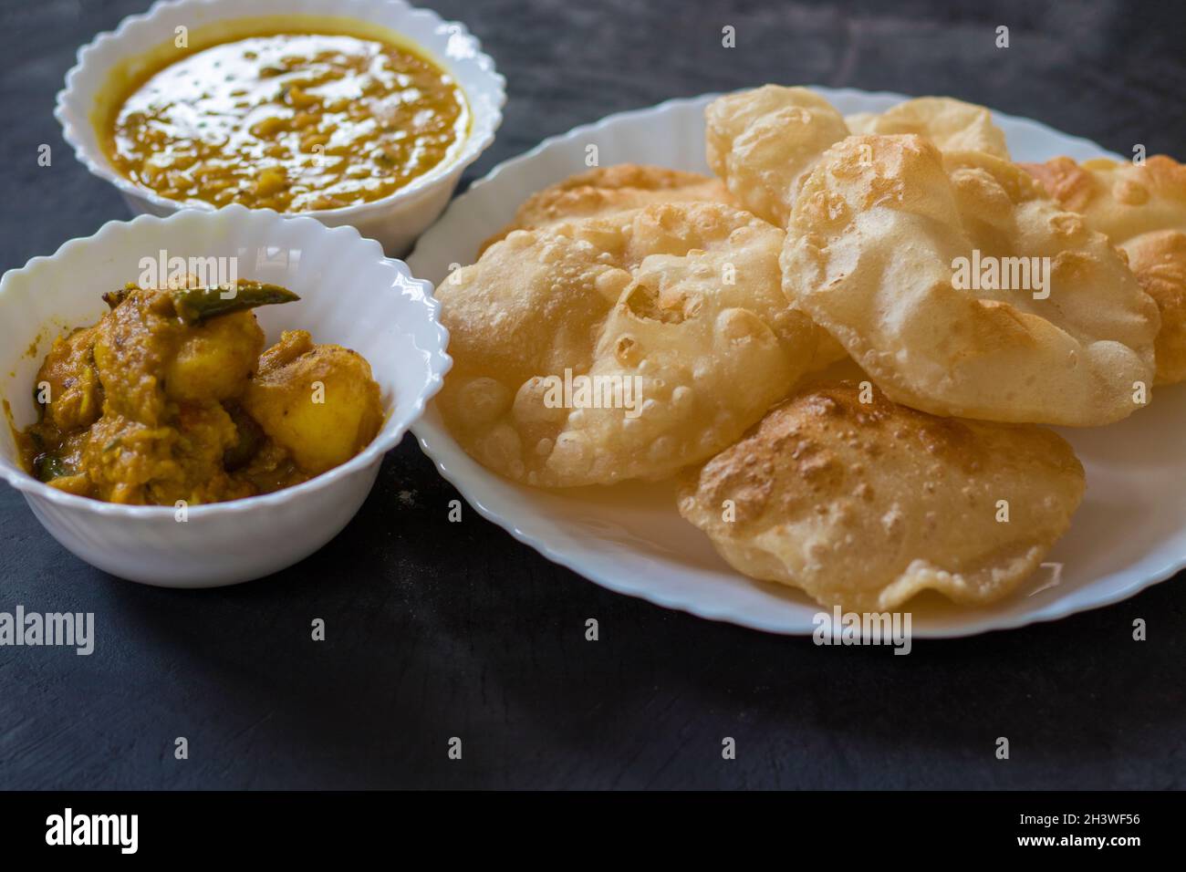 puri or poori indian delicious fast food made of flour fried with vegetable oil Stock Photo
