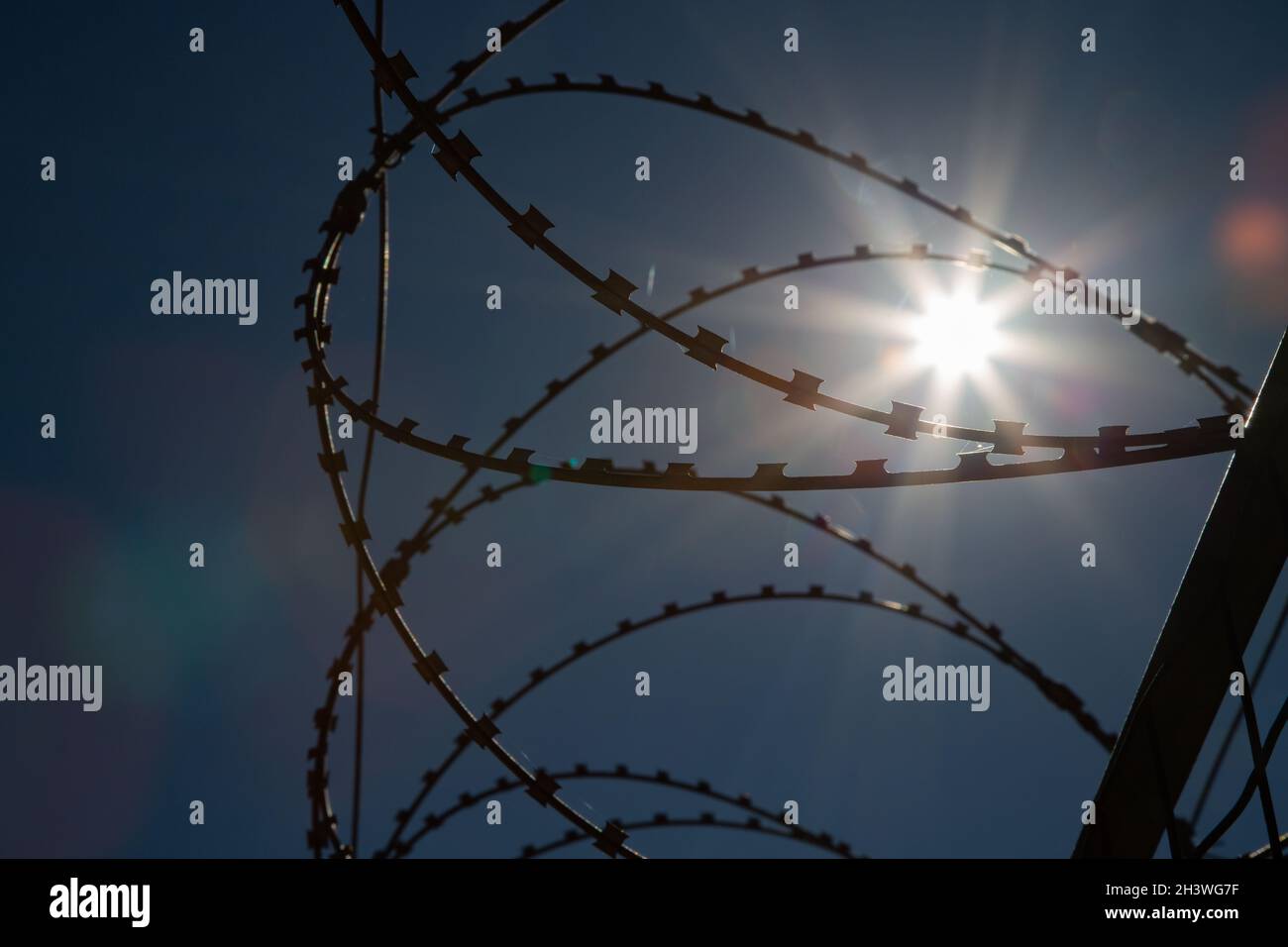 Wire top, cylindrical, portable barbed wire barrier that can be nested together for carrying and opened when used. Stock Photo