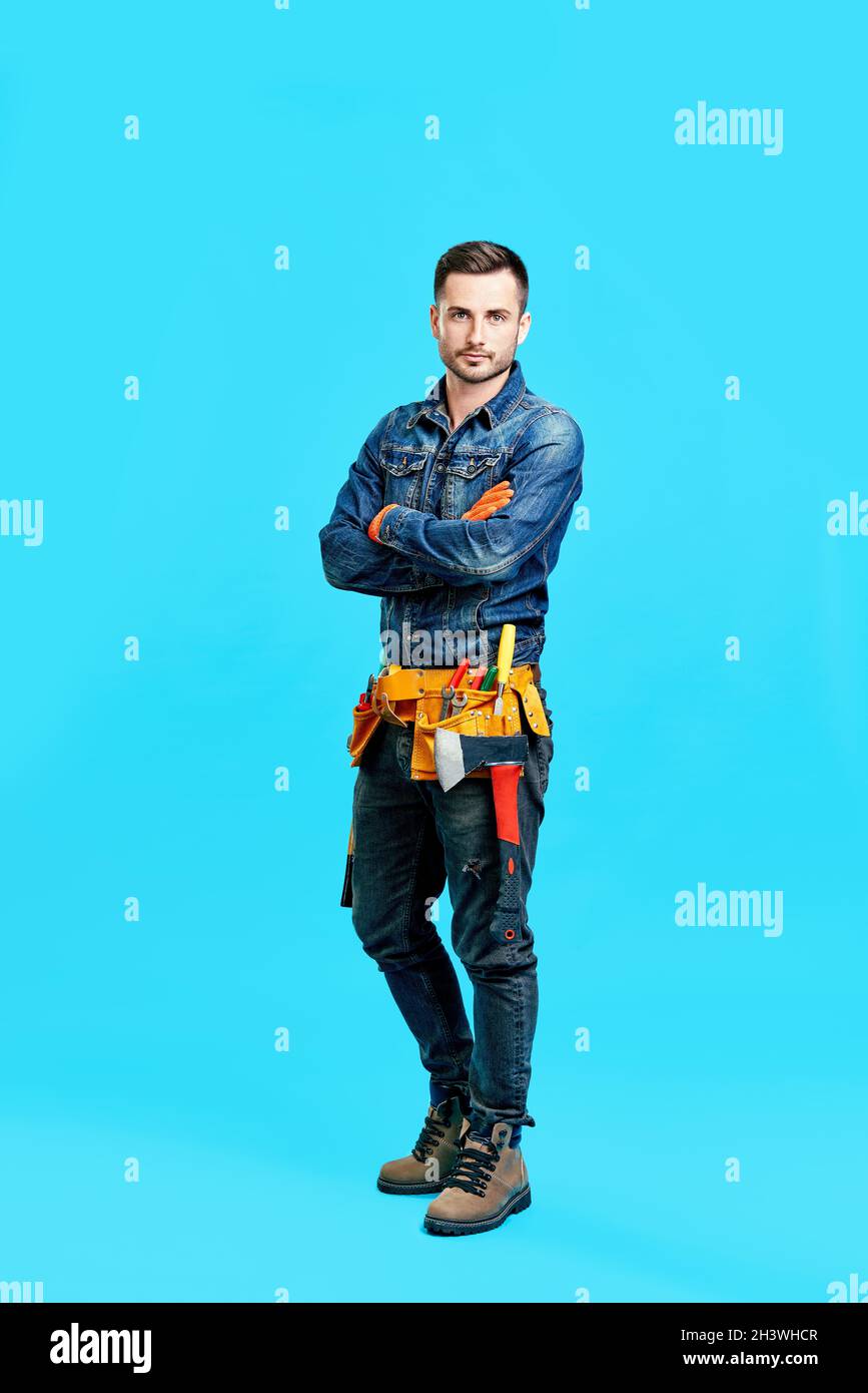 Full length portrait of confident handsome male construction worker ...