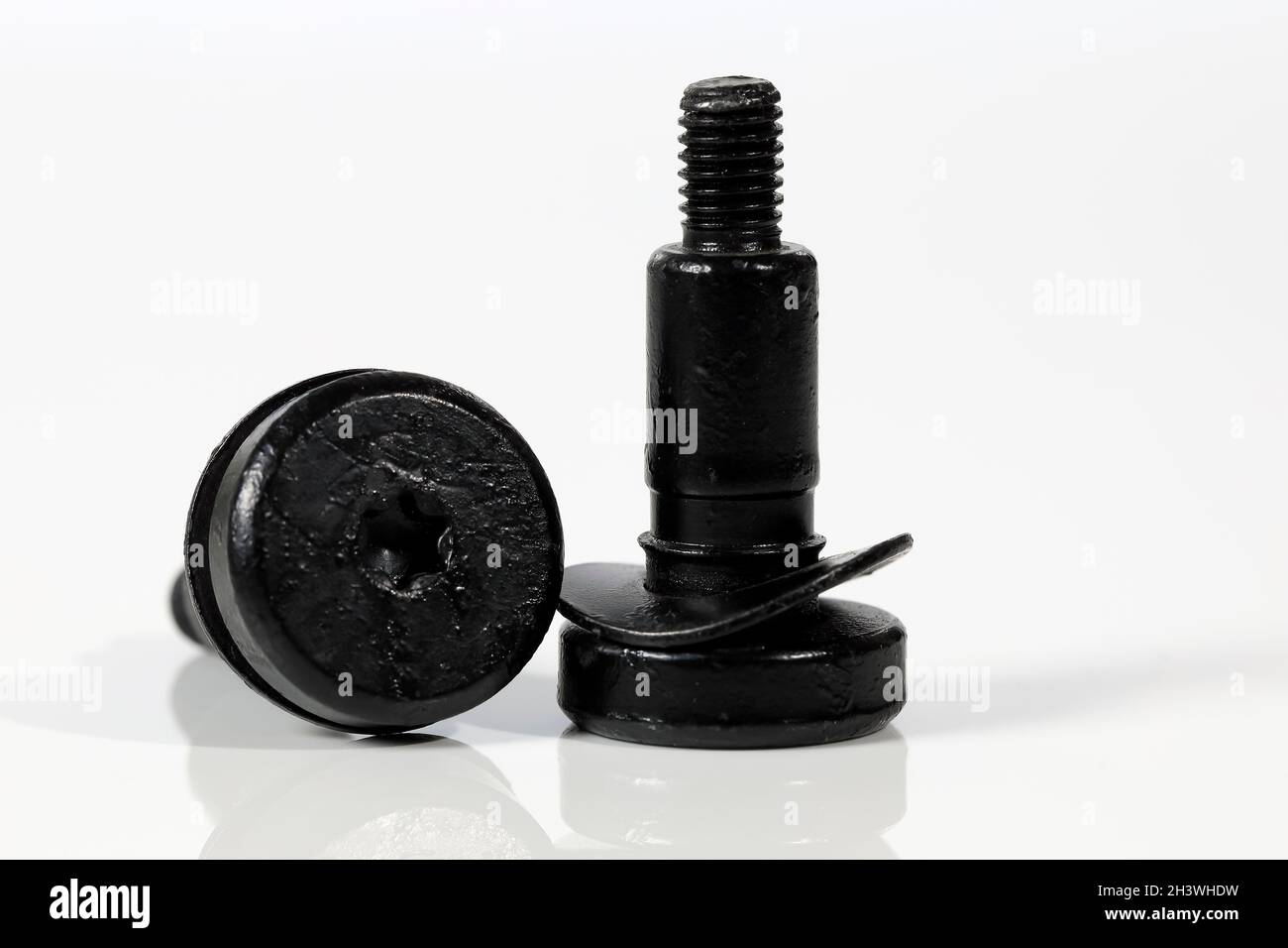 Two special purpose, black painted screw connectors of the same shape