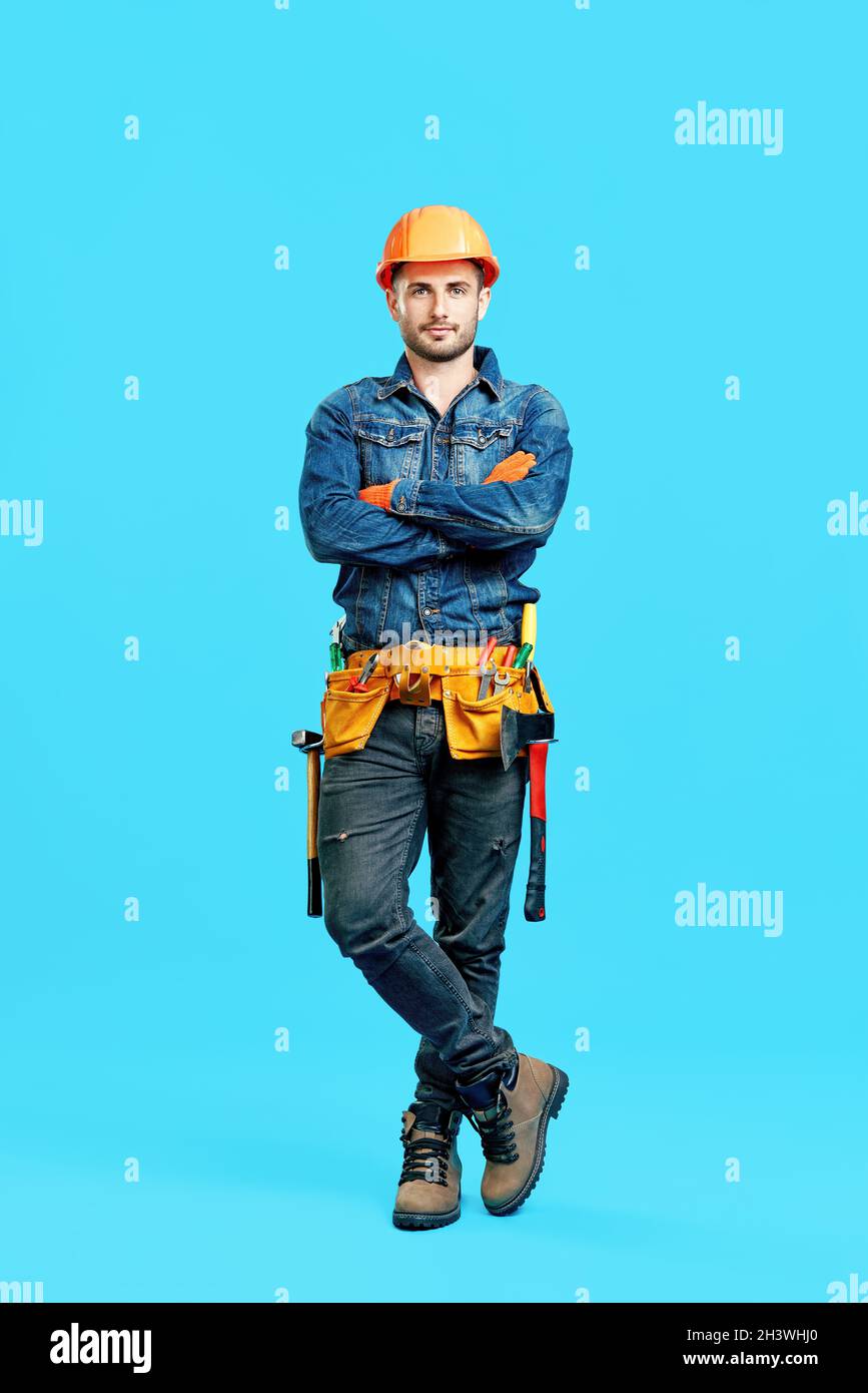 Full length portrait of confident handsome male construction worker ...