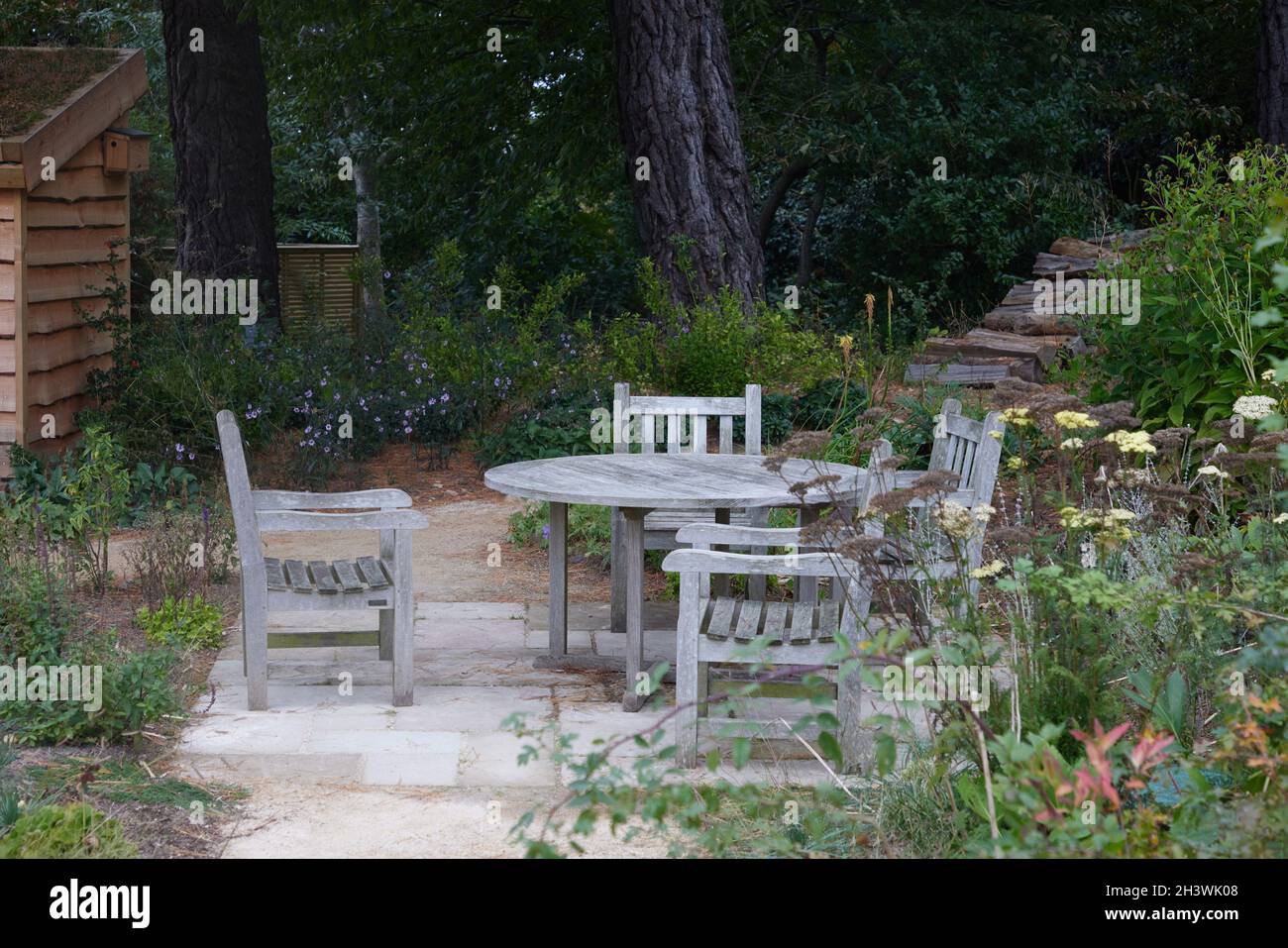 Table and chairs seen outdoors in the garden Stock Photo - Alamy
