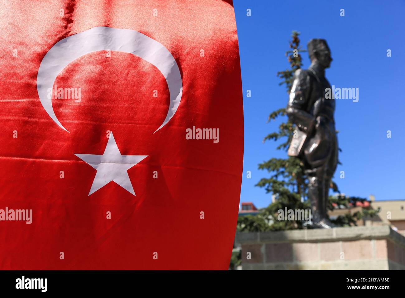 Turkish flag. Outside the clear depth of field, there is the statue of Mustafa Kemal Atatürk. Stock Photo