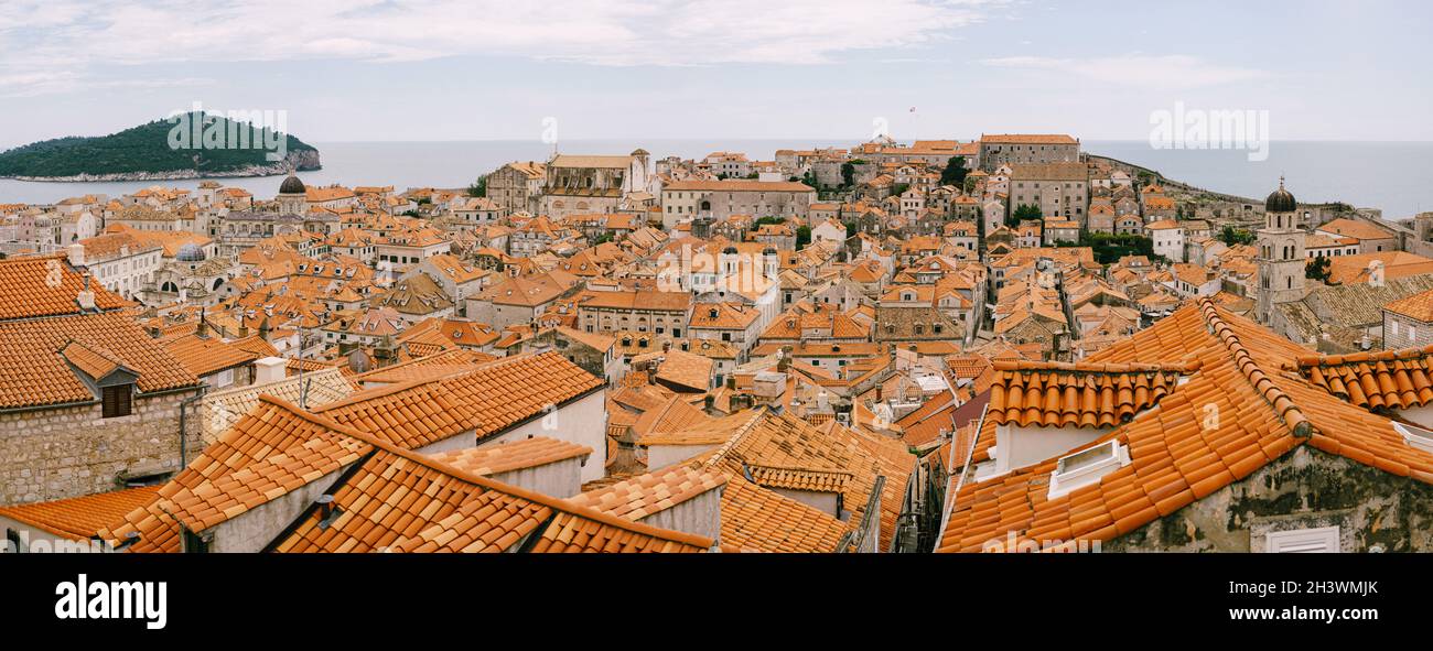 Panoramic view of the whole old city of Dubrovnik. View from the wall to the tiled roofs. Stock Photo