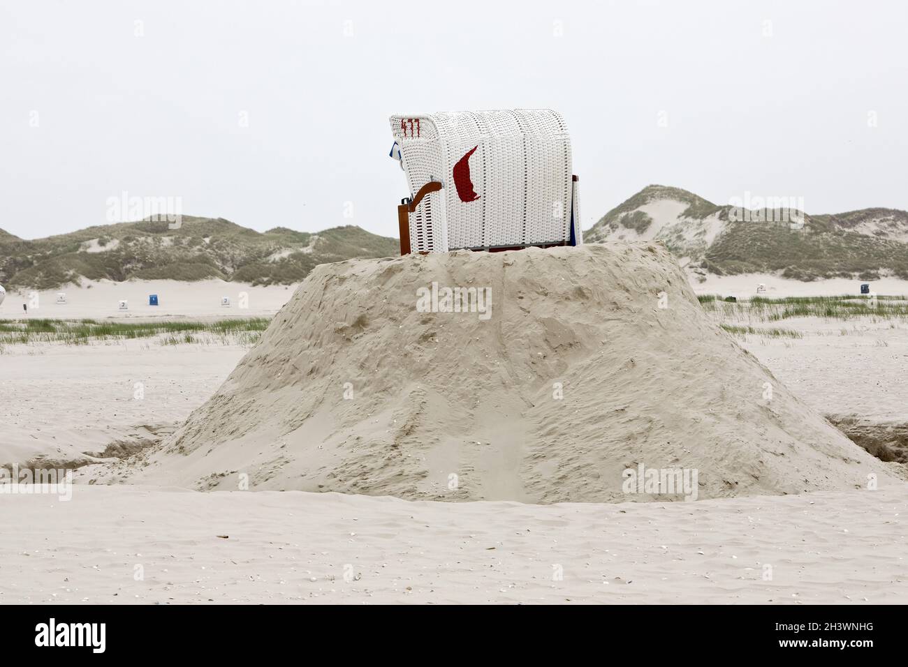 Beach chair on a built sand hill on the beach, Norddorf, Amrum Island, Germany, Europe Stock Photo