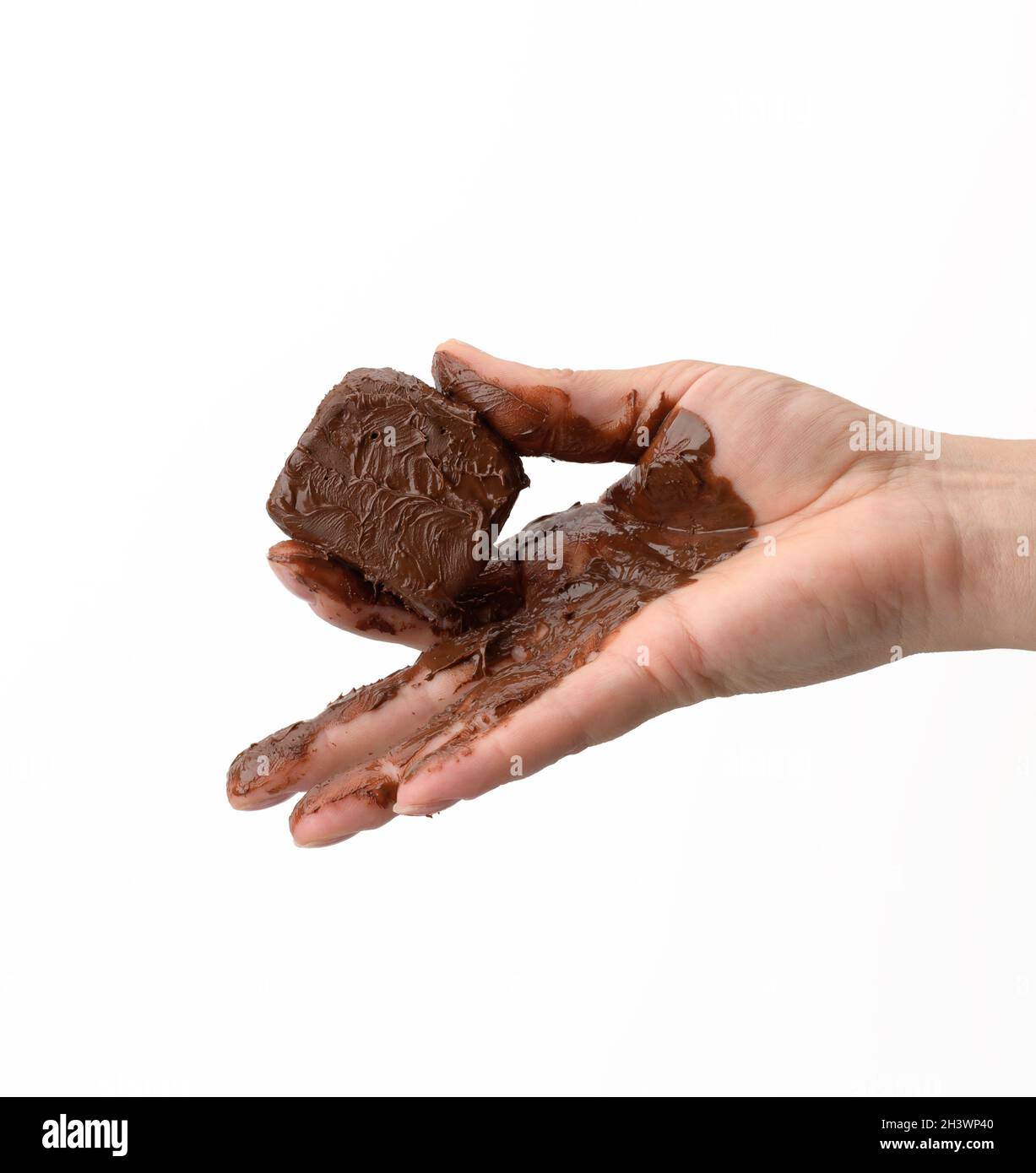 Female hand holding a melted piece of dark chocolate Stock Photo Alamy