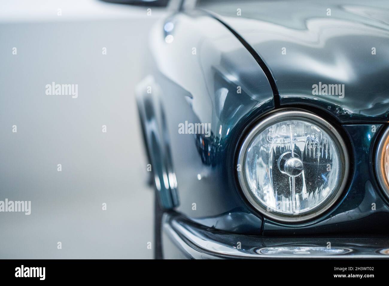 Circle lights of a polished green vintage car Stock Photo Alamy