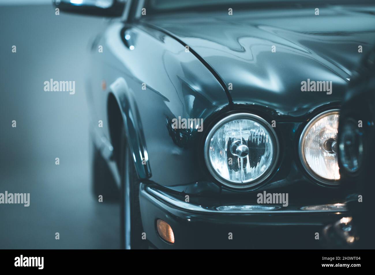 Circle lights of a polished green vintage car Stock Photo Alamy