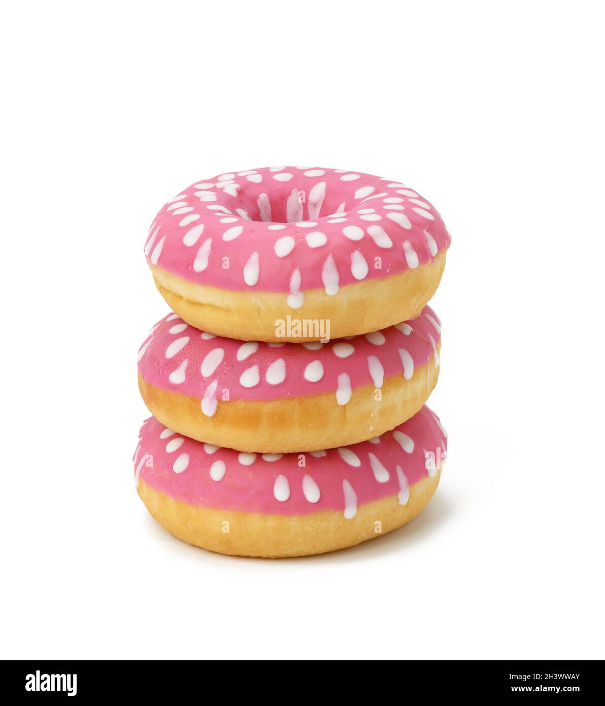 Baked round donut with pink icing and white dots isolated on white background, close up Stock Photo
