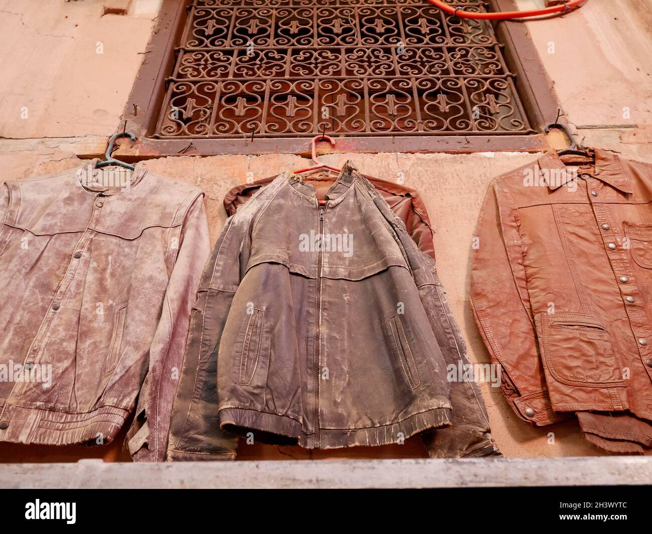 Vintage leather jackets for sale hanging in the streets of the Medina in Marrakech, Morocco. Stock Photo