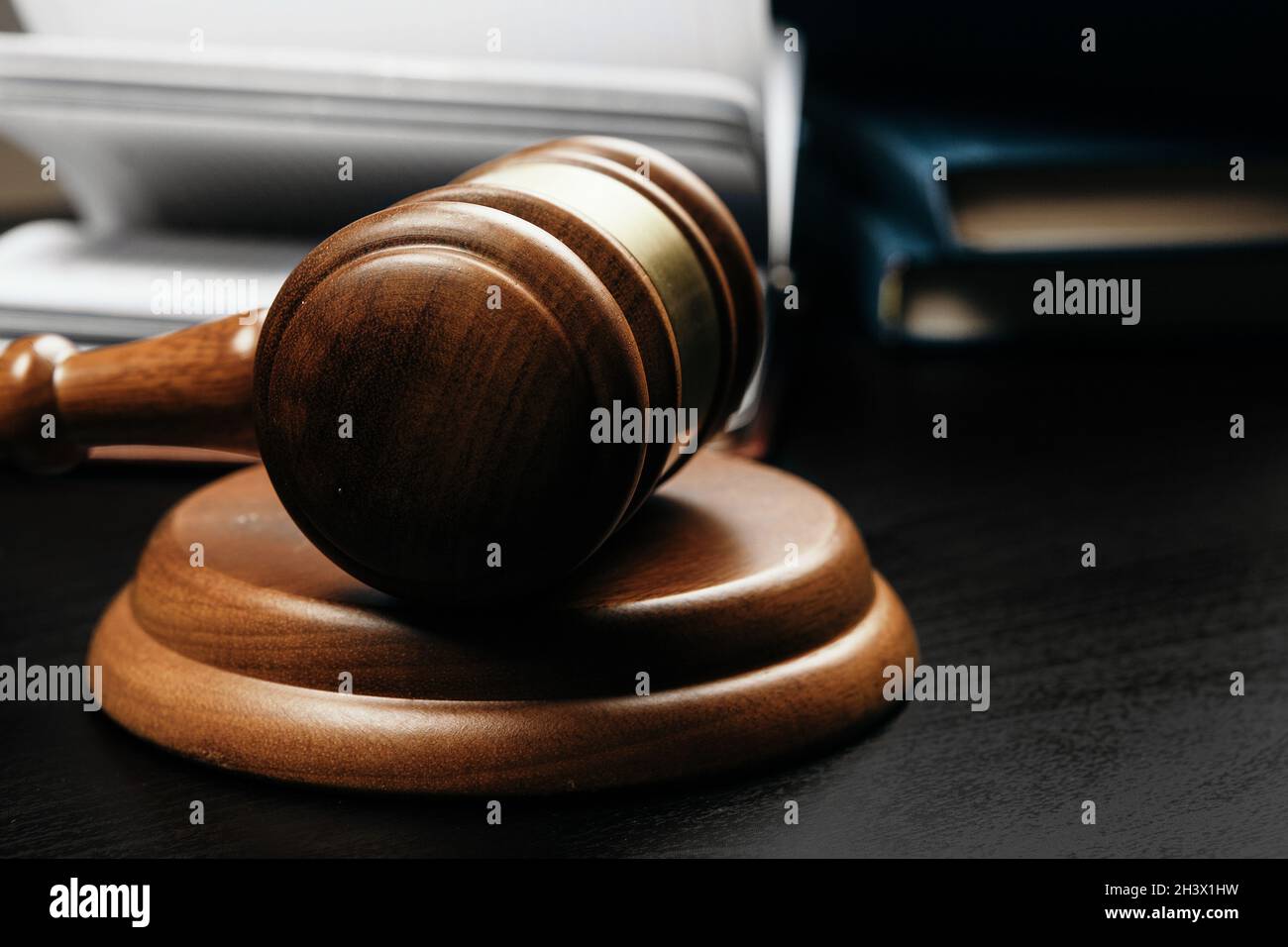 Brown wooden judge mallet on the background of open book Stock Photo