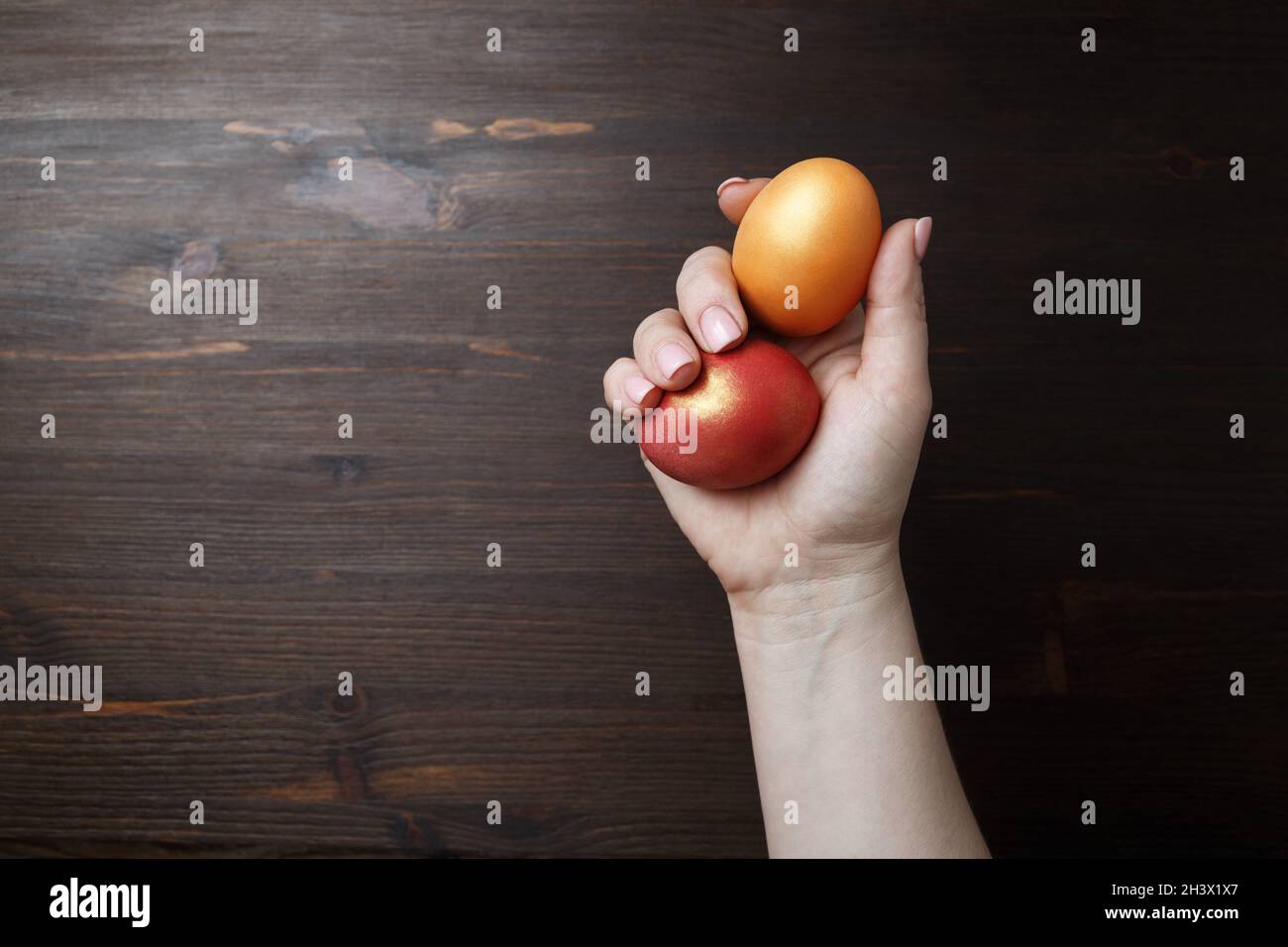Easter eggs in female hand Stock Photo