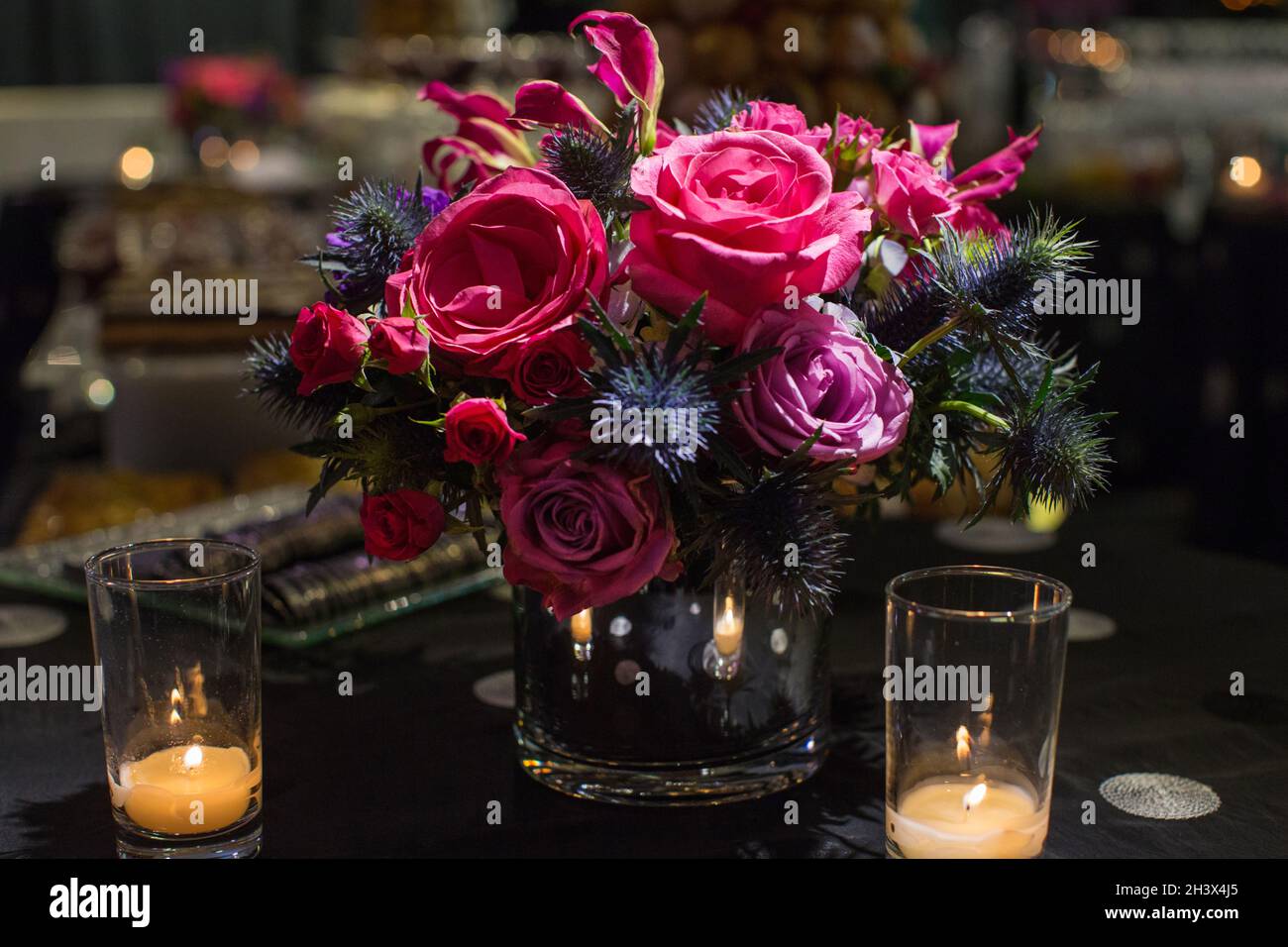 Flower arrangement of roses placed on a table at an event. Stock Photo