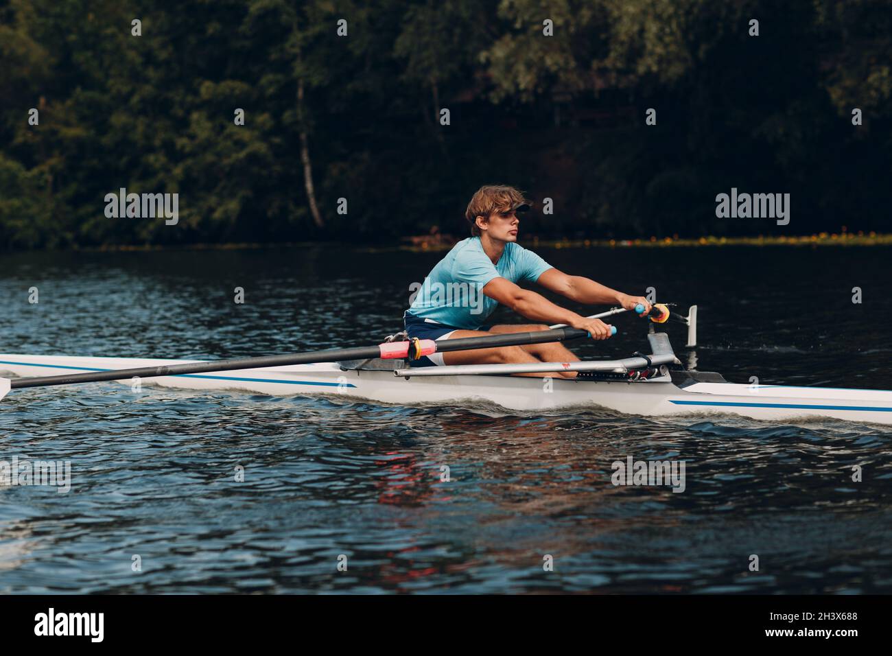 Sportsman single scull man rower prepare to competition boat regatta. Olympic games sport. Stock Photo