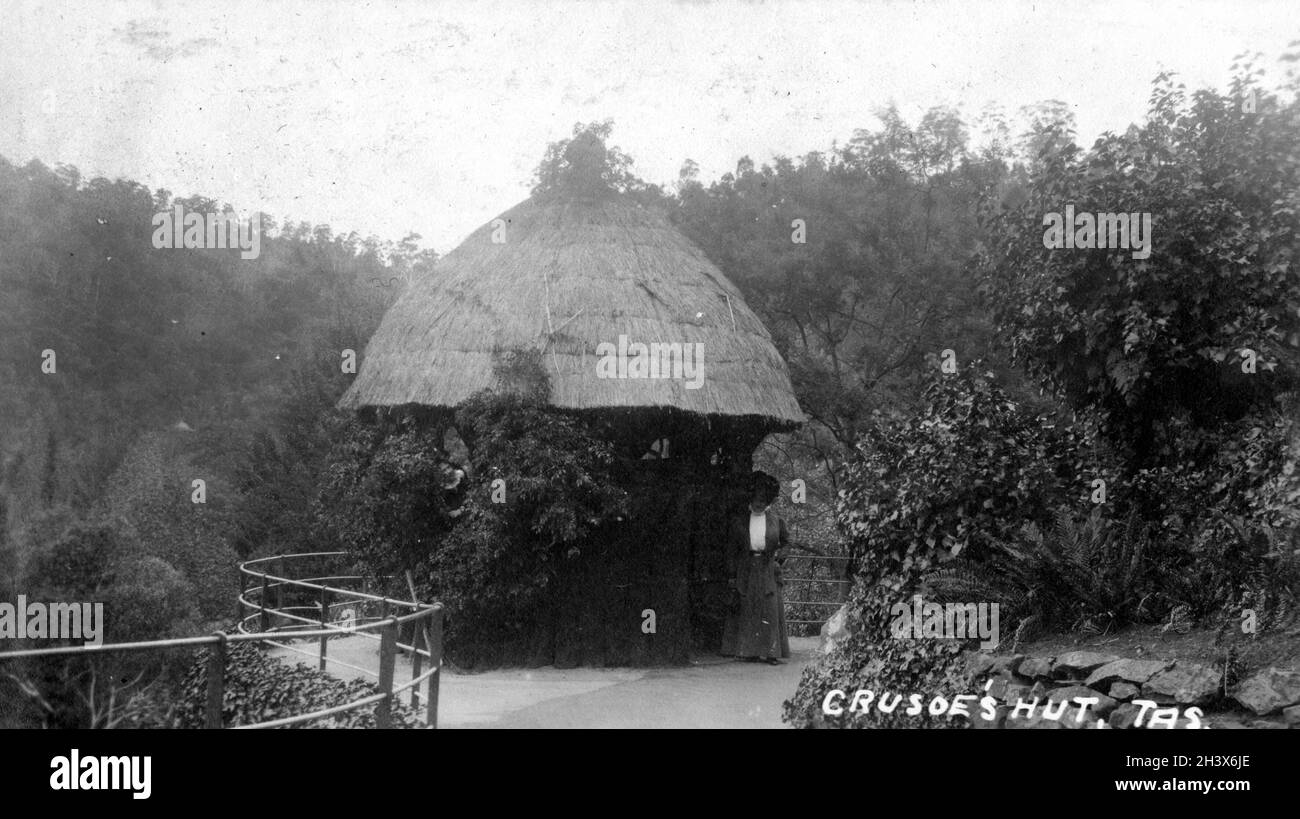 A woman standing next to Crusoe's Hut in Cataract Gorge; Launceston; Tasmania., 1909. Stock Photo