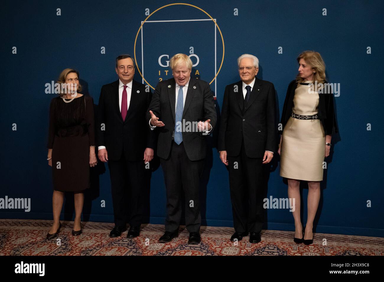 Prime Minister Boris Johnson (centre) is greeted by Italian President Sergio Mattarella (second right) and his daughter, Laura Mattarella (right) and Italian Prime Minister Mario Draghi and his wife, Maria Serena Cappello as he arrives to attend a reception and dinner at The Quirinale Palace in Rome. Picture date: Saturday October 30, 2021. Stock Photo