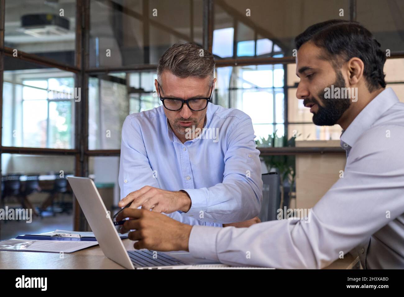 Diverse businesspeople executive team negotiating at boardroom meeting. Stock Photo