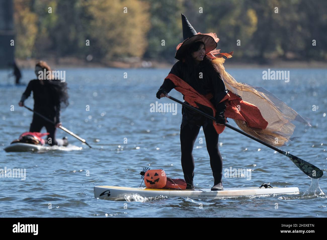 People take part in the Fourth Annual Stand Up Paddleboard Witch Paddle