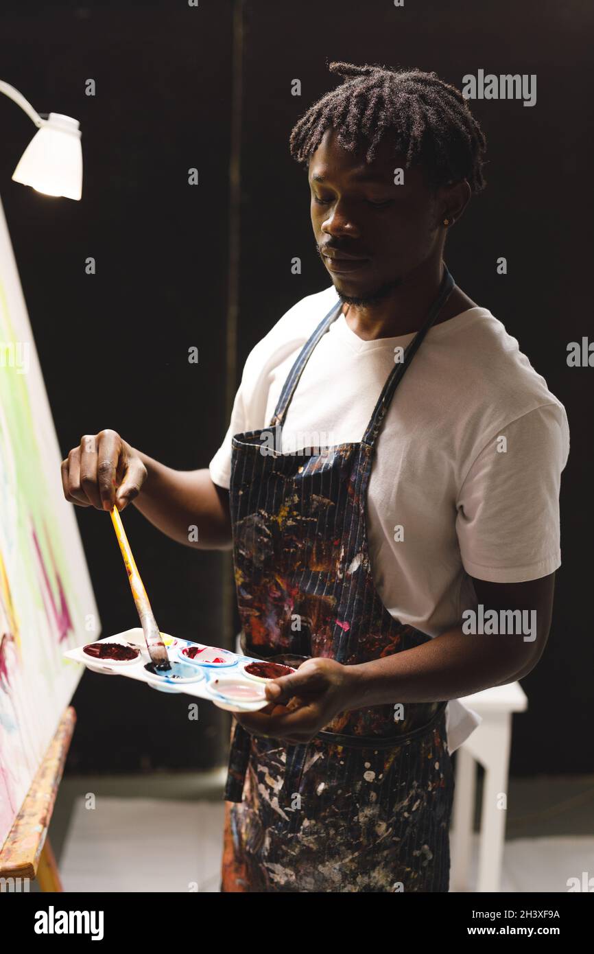 African american male painter at work painting on canvas in art studio Stock Photo Alamy African american male painter at work painting on canvas in art studio Stock Photo Alamy