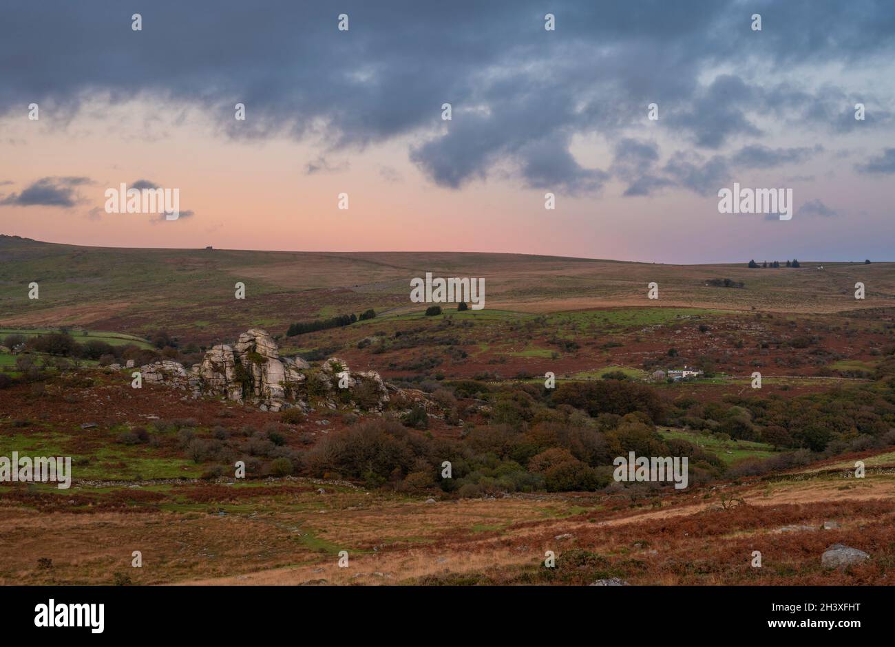 Dartmoor, Devon, UK. 30th Oct, 2021. UK Weather: Following a week of torential rain, the sky clears over Dartmoor revealing vibrant autumnal colours emerging in the rugged moorland. Image shot from the West of the National Park near Heckwood Tor looking out towards Vixen Tor at sunset. Credit: PQ/Alamy Live News Stock Photo