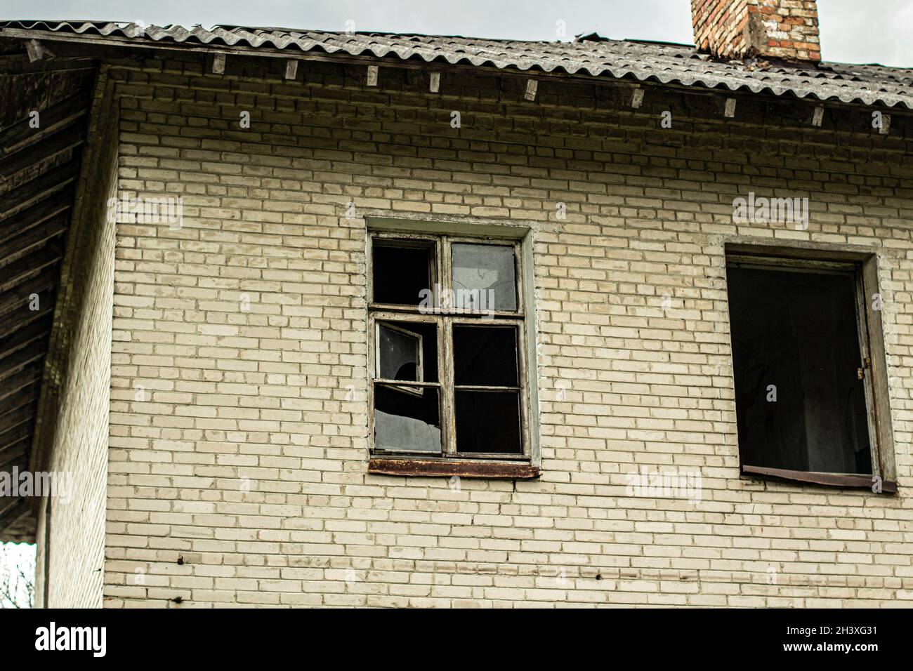 An abandoned house with broken windows. Old building in the city ...