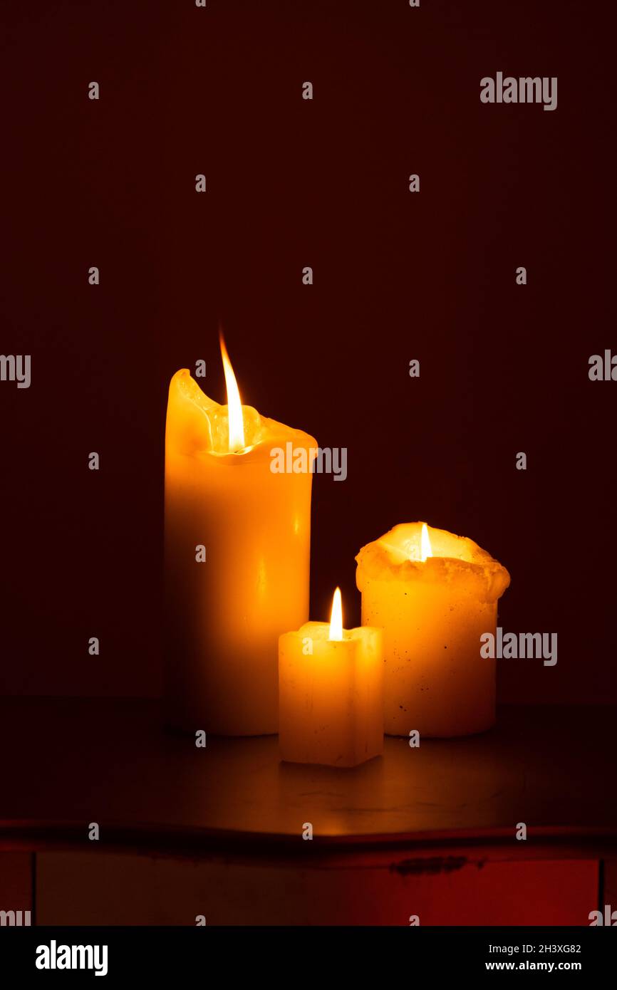 Candle on the table. Dark fire. Candle light. Halloween, scary candle