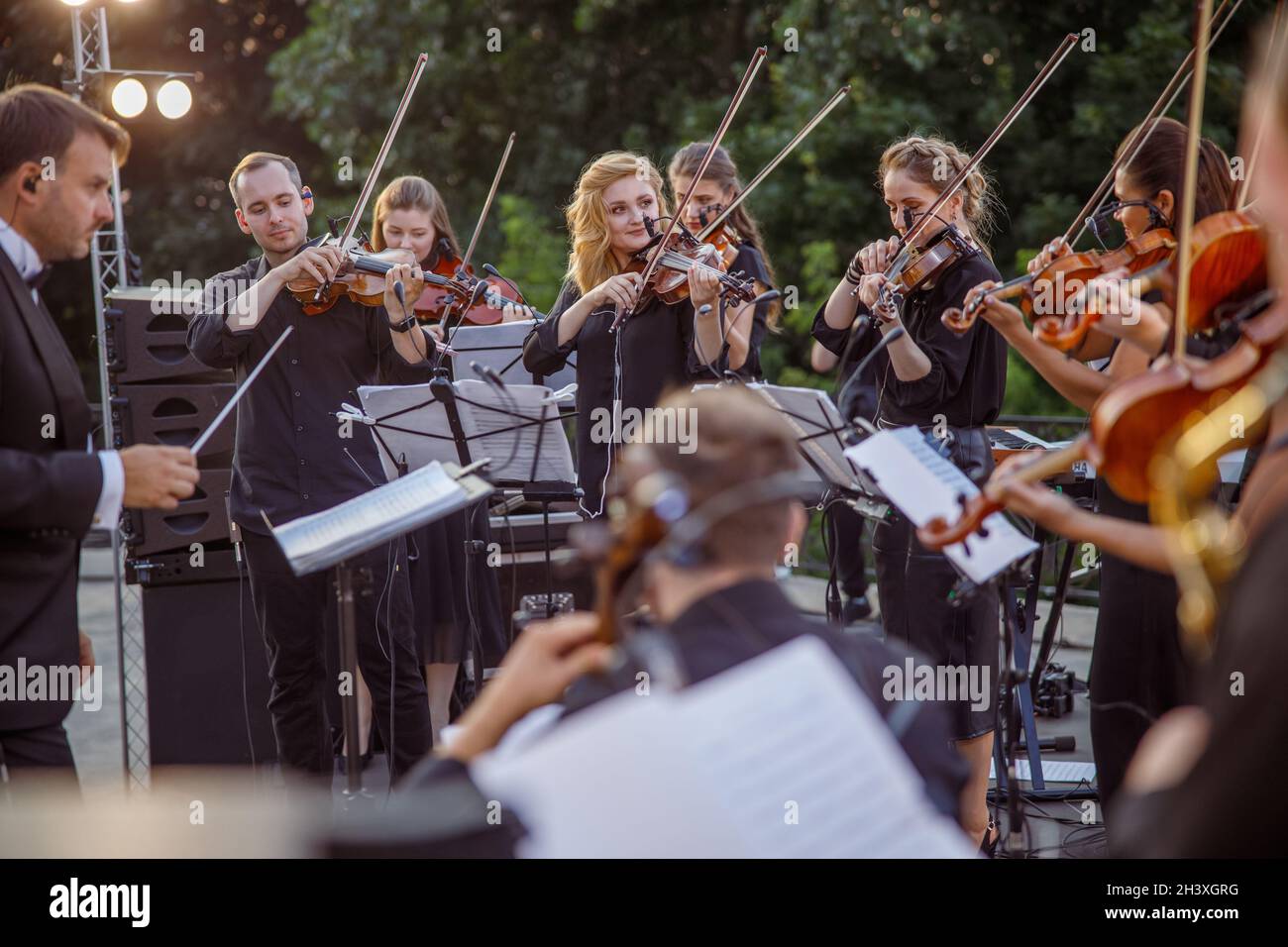 Violin players playing classic instrumental music outdoors Stock Photo