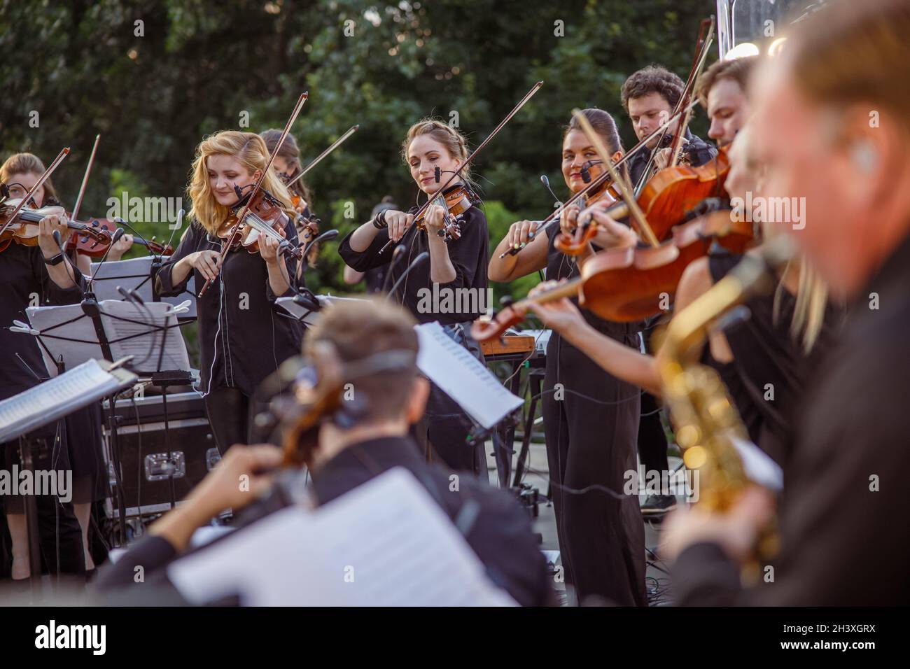 Violin players playing classic instrumental music on the street Stock