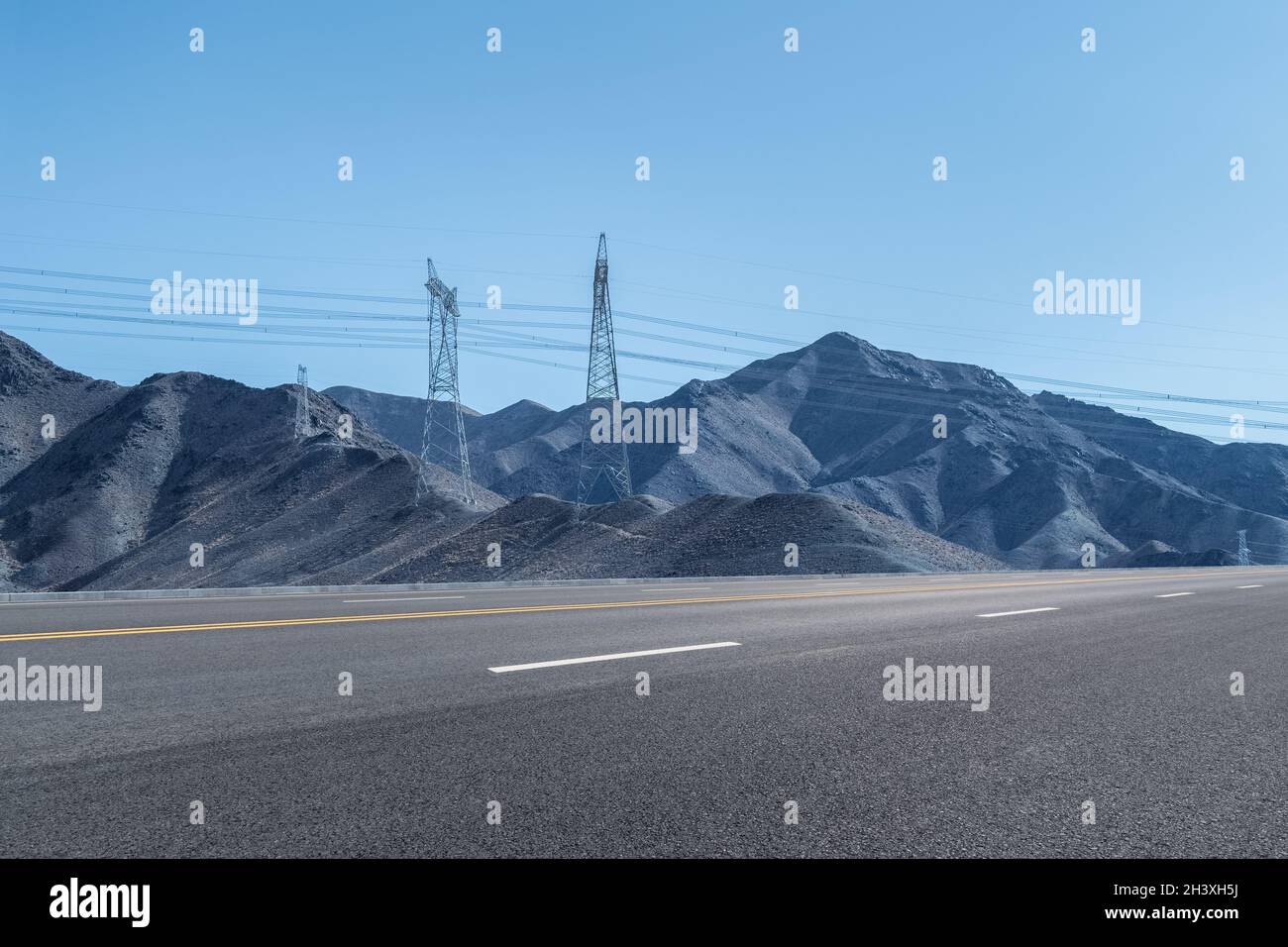 Highway background and power transmission tower on the mountain Stock Photo