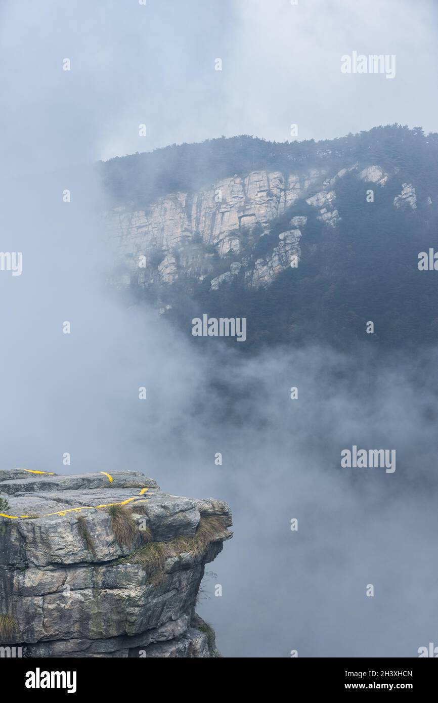 Foggy valley with cliff rock Stock Photo