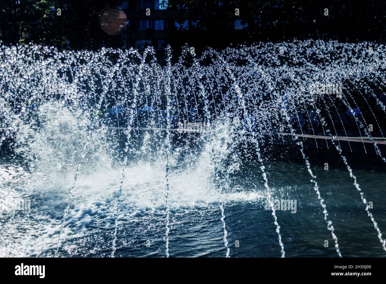 Real fresh splash fountain spray on sunny happy summer day Stock Photo