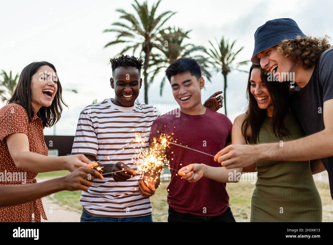 Happy multiracial people laughing and having fun together with sparkles ...