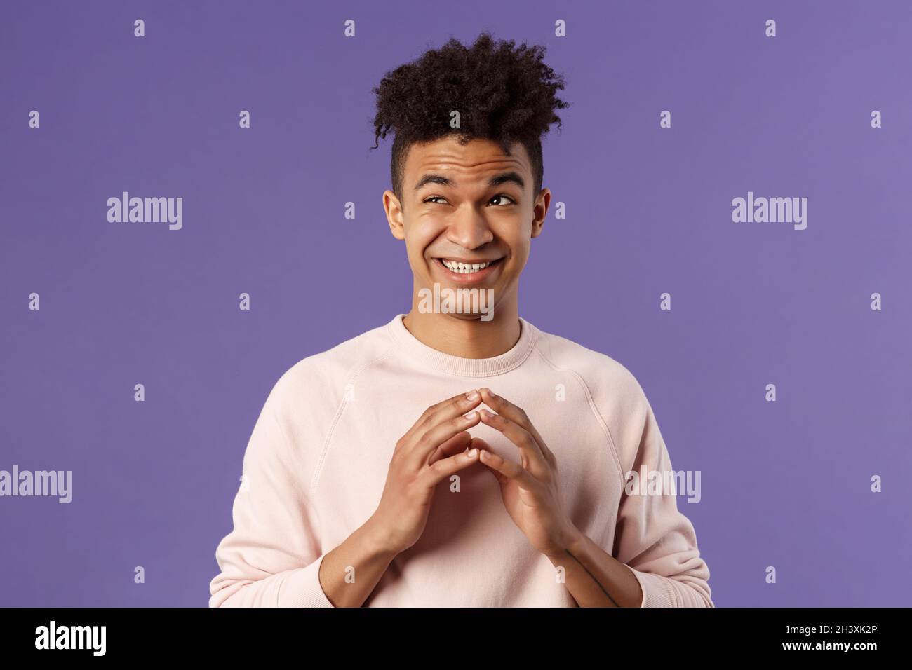 Close-up portrait of creative young hispanic guy steeple fingers while making-up great plan or joke, look away daydreaming, sche Stock Photo