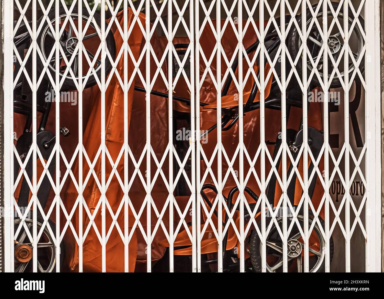 White closed modern metal lattice gates at day for keeping things Stock Photo