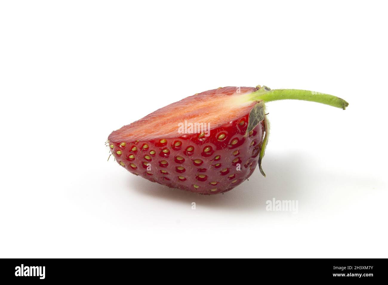 Strawberries in section lies sideways isolated on a white background. Full focus. Stock Photo