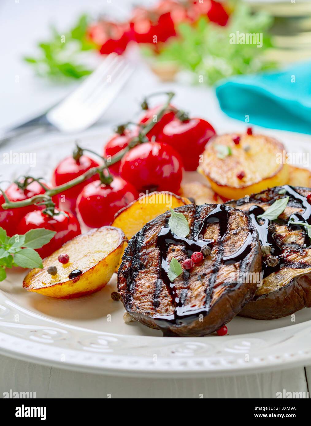 Eggplant steaks with vegetables. Stock Photo
