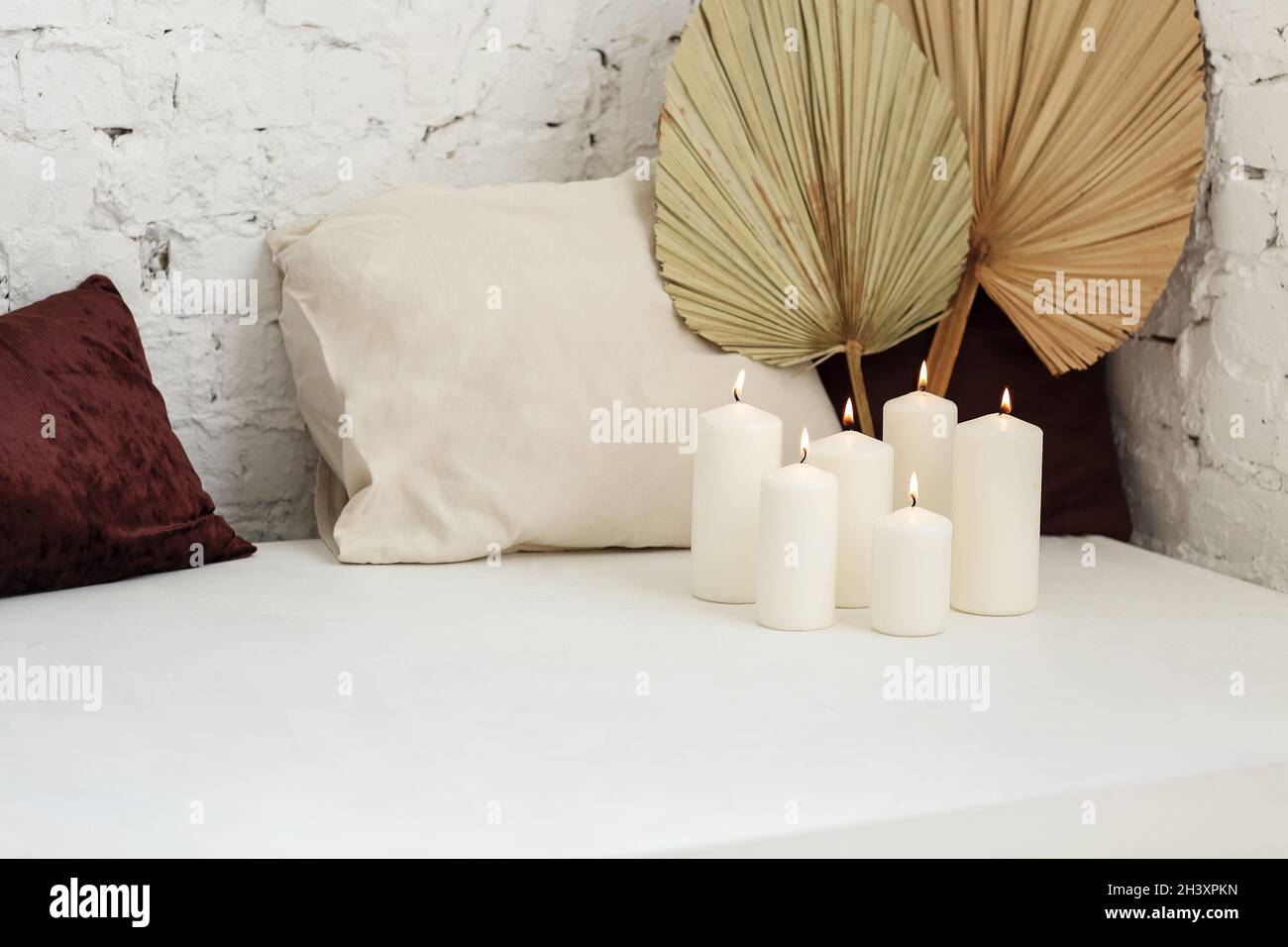 Meditation place with candles and smudge stick in yoga studio Stock