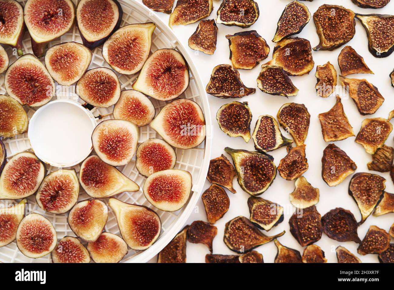 Sliced fresh and dried figs lie on the table. Top view Stock Photo