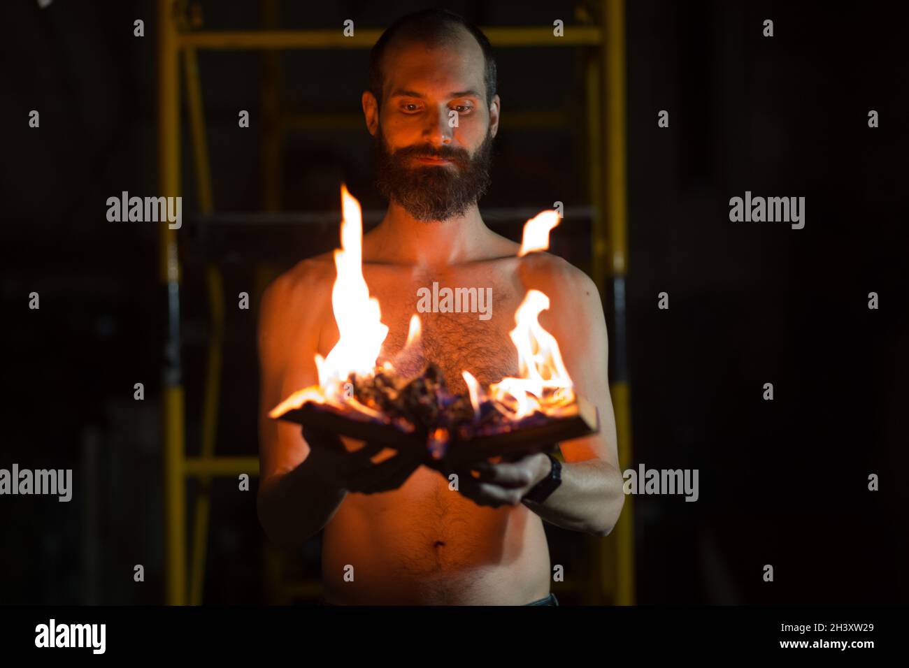 Man hold burning book in his hands. Stock Photo