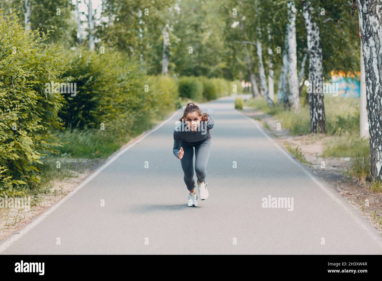 Athletic woman on track starting to run. Jogging girl Stock Photo Alamy