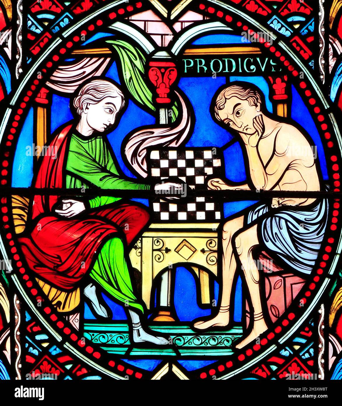 Parable of The Prodigal Son, by Adolph Didron of Paris, 1859.  Stained glass window, Feltwell Church, Norfolk, England, UK. The Prodigal Son gambles Stock Photo