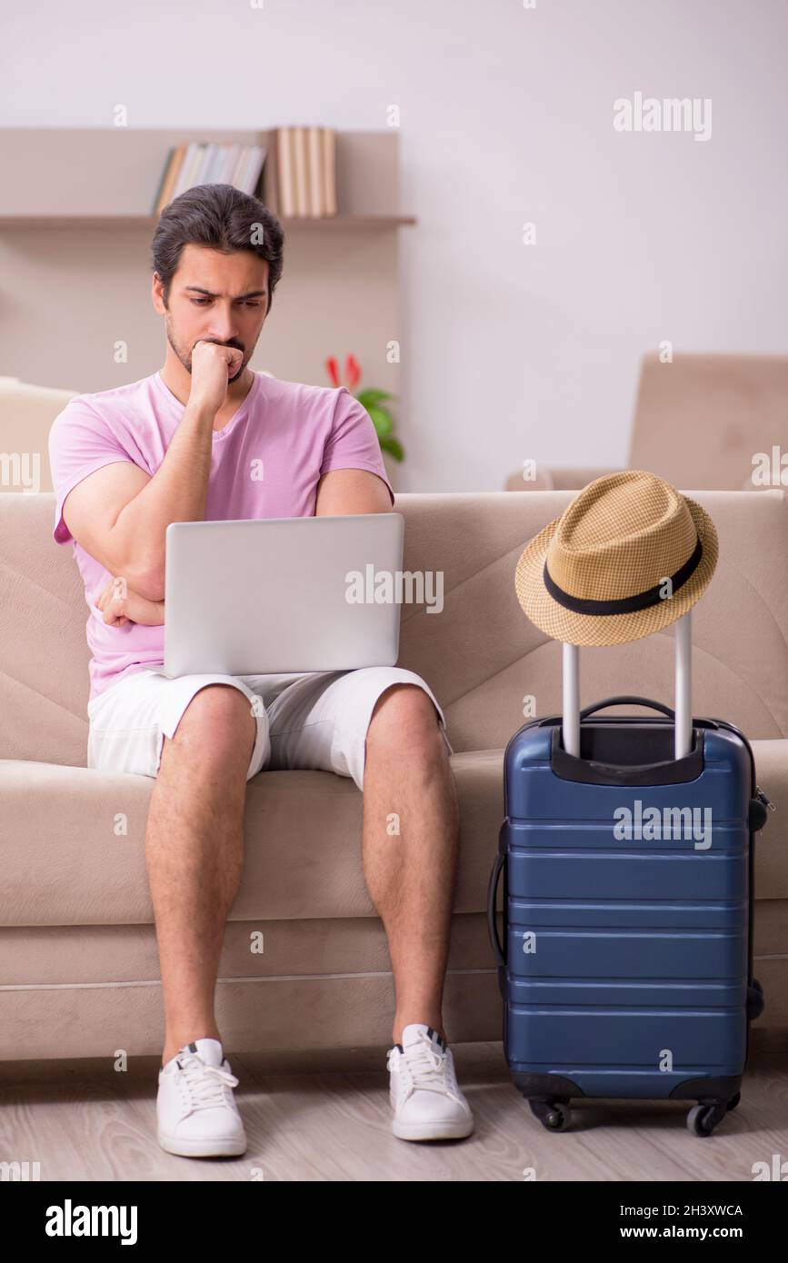 Young man preparing for trip at home Stock Photo