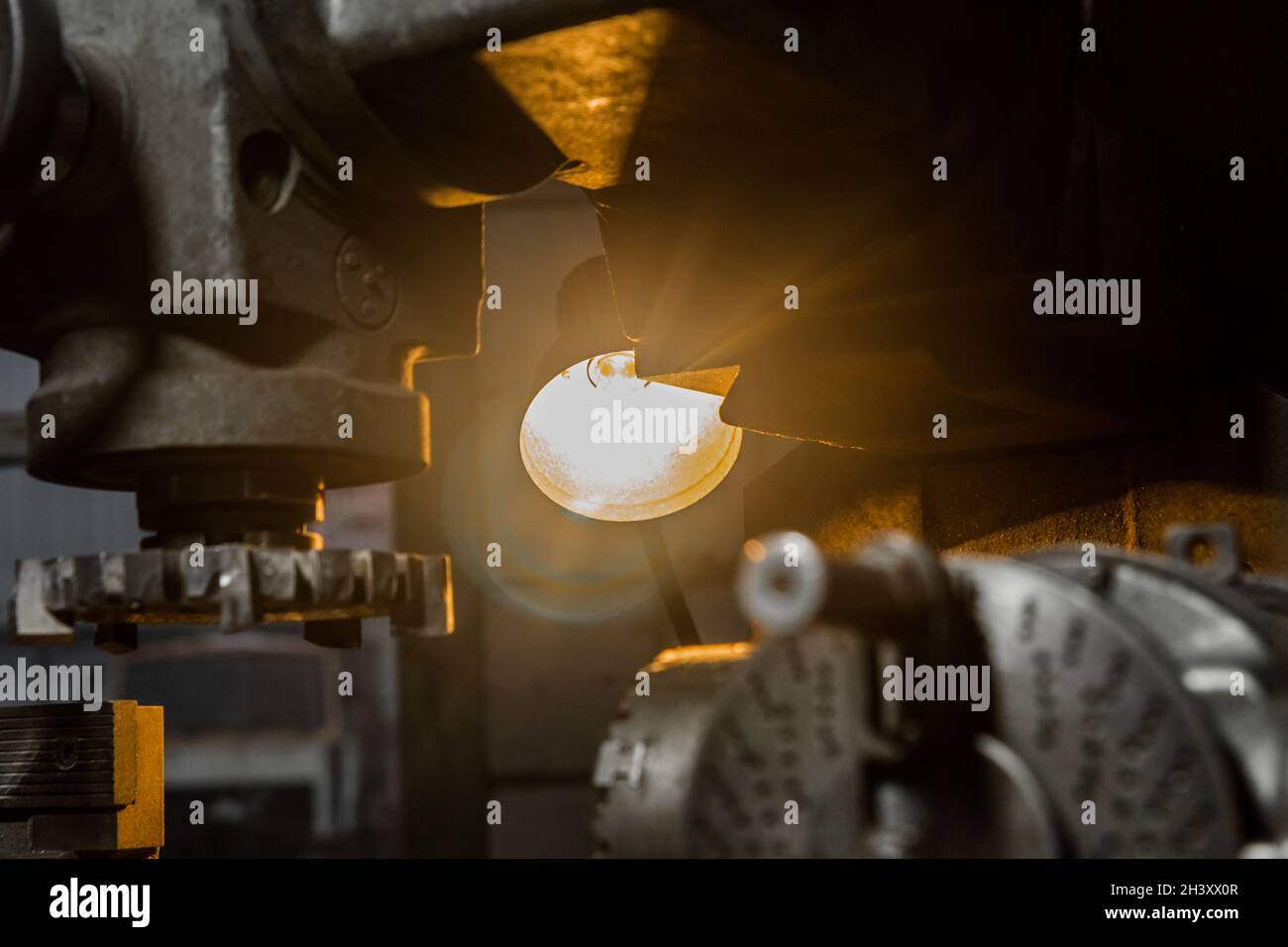 Industrial lighting element lamp on an old milling machine for metal processing in an industrial plant. Stock Photo