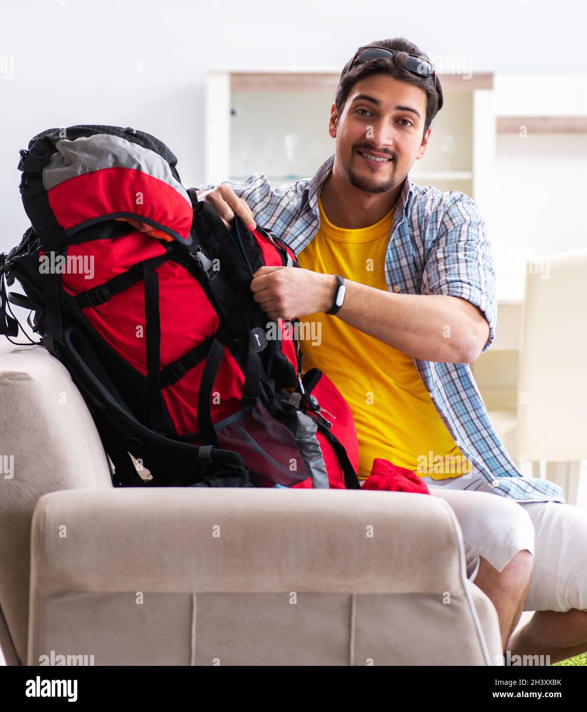 Backpacker packing for his trip Stock Photo Alamy